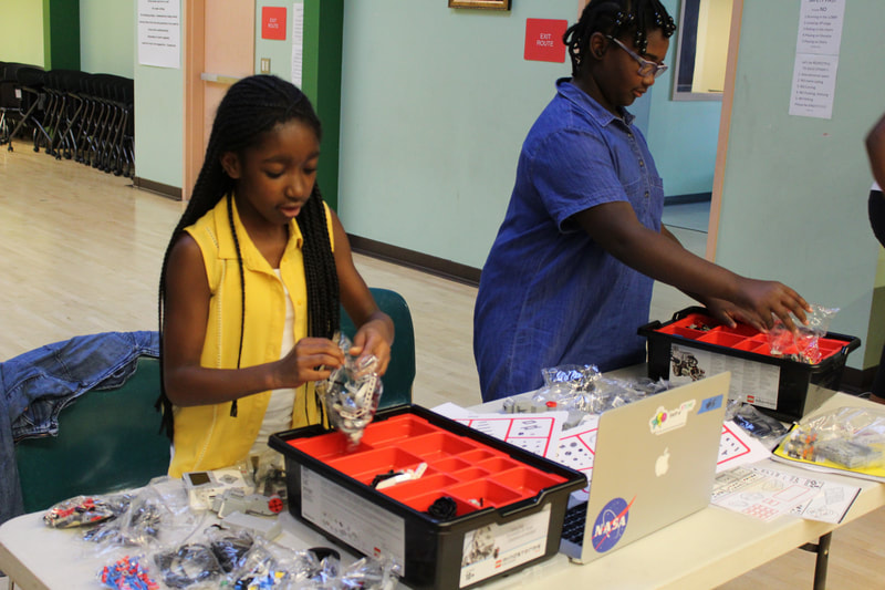 Young ladies preparing for Lego Robotics competition